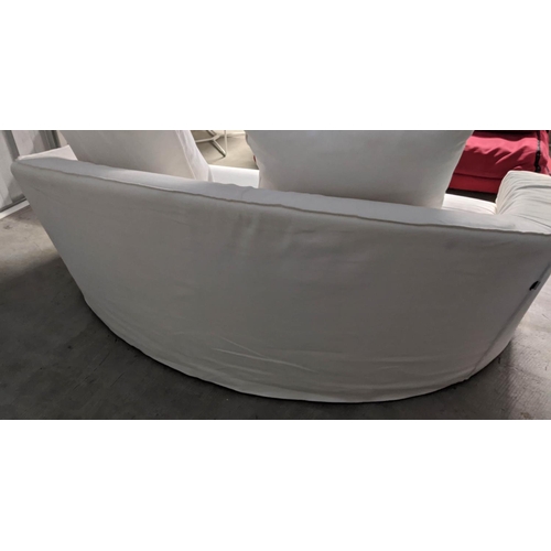 418 - POLIFORM SOFA, of curved form, in a loose white cover, 180cm W.