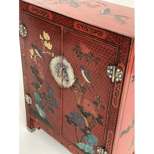 225 - CHINOISERIE CABINET, Chinese scarlet lacquered and gilt decorated with two doors, 59cm x 28cm x 77cm... 