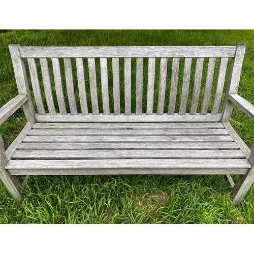 248 - GARDEN BENCH, silvery weathered teak of slatted and pegged construction, 152cm W.