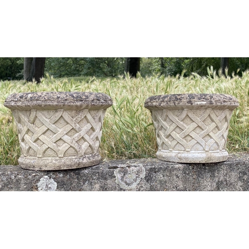 261 - GARDEN PLANTERS, a pair, well weathered reconstituted stone, circular with basket weave sides and sc... 