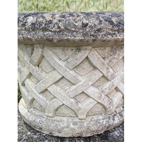 261 - GARDEN PLANTERS, a pair, well weathered reconstituted stone, circular with basket weave sides and sc... 