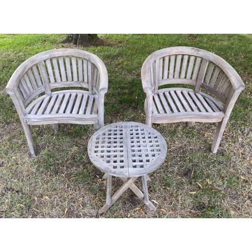 131 - GARDEN CURVED ARMCHAIRS, a pair, weathered teak each slatted with rounded backs, together with an un... 