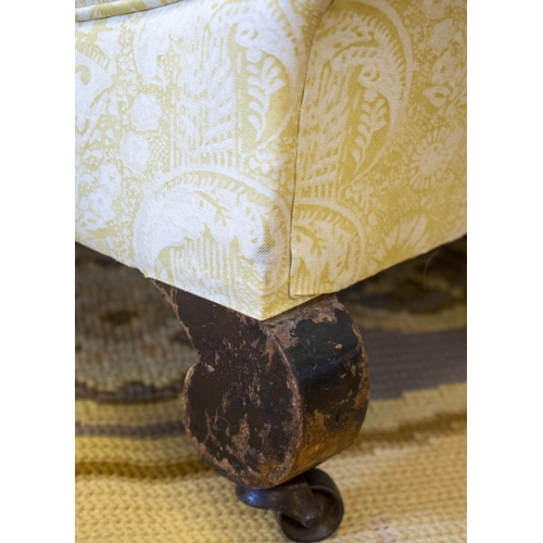 154 - ARMCHAIR, 80cm H x 85cm W, late 19th/early 20th century in patterned yellow fabric on steel castors.