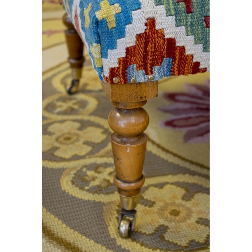 189 - STOOL, 44cm H x 94cm W x 66cm D, kilim and beechwood on brass castors.