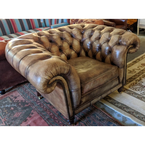 201 - CHESTERFIELD ARMCHAIR, 133cm W x 85cm D, from Fleming Howland, in buttoned brown leather.