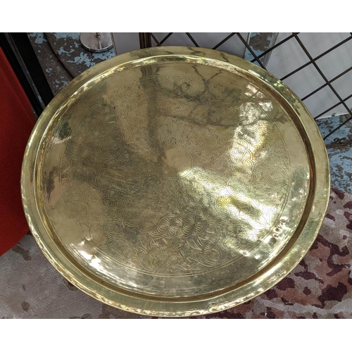 95 - CIRCULAR BRASS TRAY, 73cm diam x 53cm H decorated on a wooden stand.