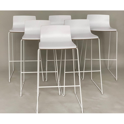 298 - BAR STOOLS, a set of six stacking with white seats and metals supports, 55cm w x 90cm H.