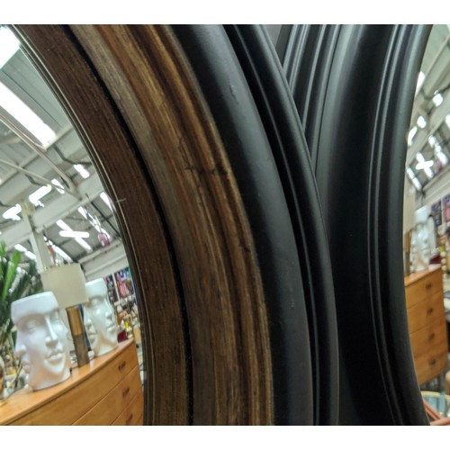 353 - CONVEX MIRRORS, a pair, 49cm diam ebonised  with a gilt inner slip. (2)