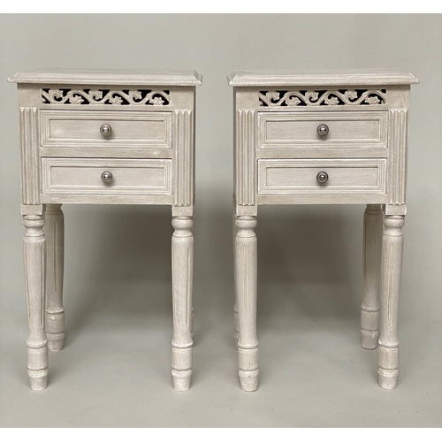 121 - BEDSIDE CHESTS, a pair, French style traditionally grey painted each with pierced frieze and two dra... 