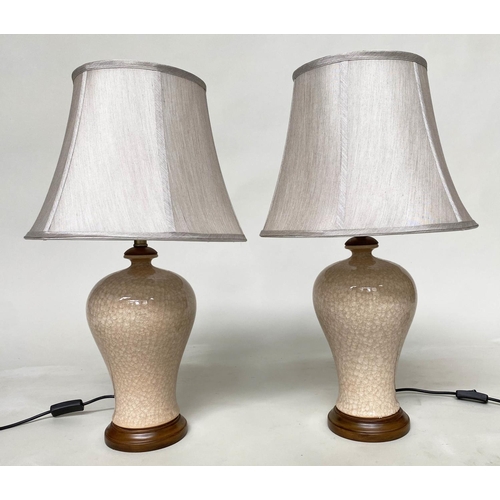 134 - TABLE LAMPS, a Chinese cream ceramic of baluster vase form with crackelure effect and silk style sha... 