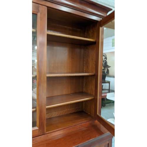 373 - GRANGE BOOKCASE, 147cm W x 216cm H x 55cm D with two glazed doors enclosing shelves above three draw... 