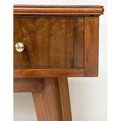 279 - WRITING TABLE, 1970s teak and Indian laurel with three frieze drawers and tapering out swept support... 