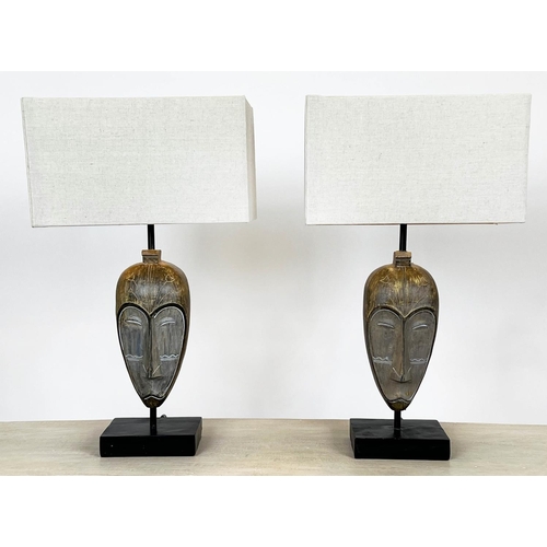 123 - TABLE LAMPS, a pair, African Tribal mask design, with shades, 49cm H. (2)