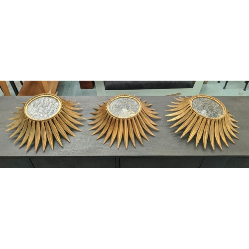 206 - STARBURST WALL LIGHTS, a set of three, each 40cm W, with a crinkle glass and gilt metal frames in a ... 