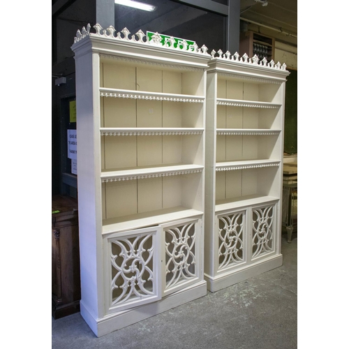 217 - BOOKCASES, 224cm H x 110cm W x 38cm D, a pair, Gothic revival white painted, each with fixed open sh... 