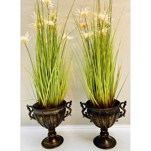 360 - FAUX GOLDEN OATS GRASS PLANTS, pair, 80cm H x 30cm W approx., in twin handled pedestal urns, antique... 