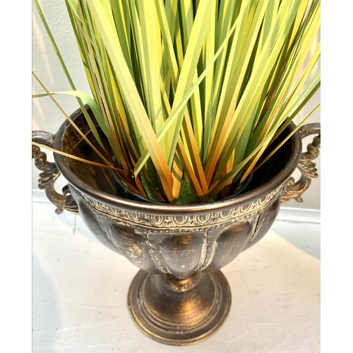 360 - FAUX GOLDEN OATS GRASS PLANTS, pair, 80cm H x 30cm W approx., in twin handled pedestal urns, antique... 