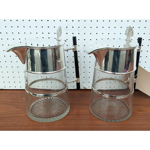 412 - CHRISTOPHER DRESSER STYLE CLARET JUGS, pair, silver plated and glass bodies, 21cm H. (2)