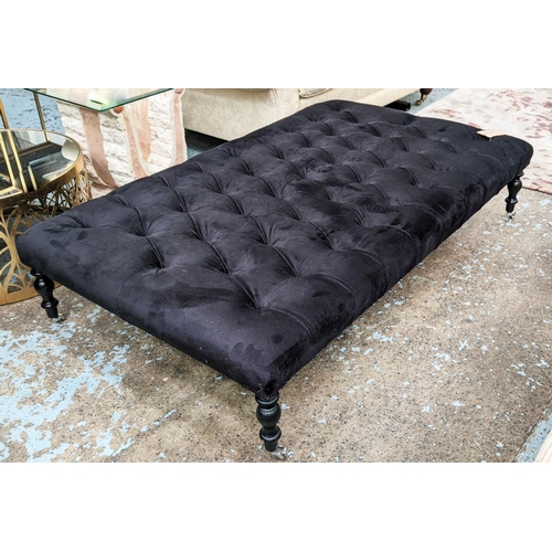 415 - LARGE FOOTSTOOL, deep buttoned navy blue upholstery, raised on ebonised ash turned legs with castor ... 