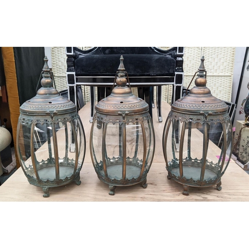 418 - HANGING LANTERNS, set of three, antiqued copper finish, barrel form, glazed sides, 46cm H x 25cm dia... 