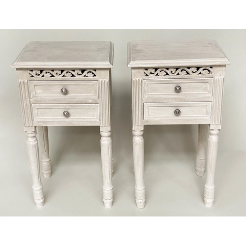 138 - BEDSIDE CHESTS, a pair, French style traditionally grey painted each with pierced frieze and two dra... 