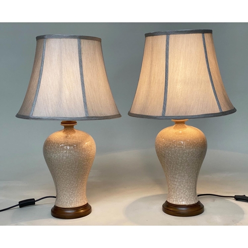 145 - TABLE LAMPS, a pair, Chinese cream ceramic of baluster vase form with crackelure effect and silk sty... 