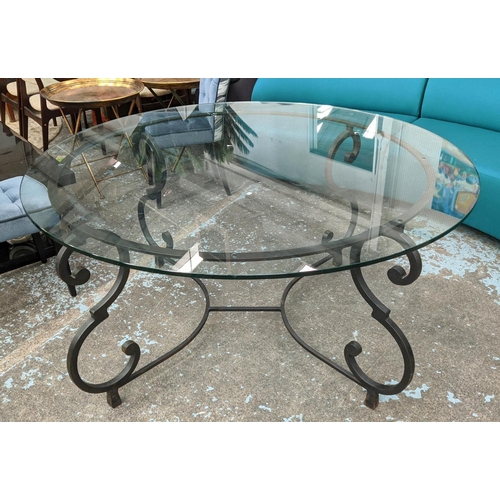 268 - CIRCULAR GLASS DINING TABLE, 160cm W x 78cm H, on a scrolled wrought metal base.