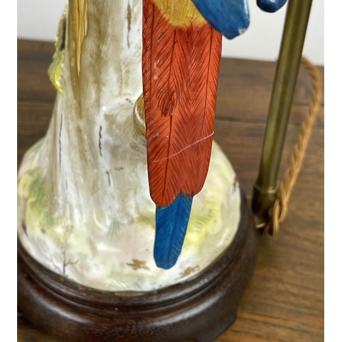 4 - PARROT LAMPS, a pair, porcelain modelled perched on three stumps in bright painted coloured, 41cm H.... 