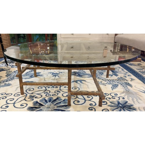 265 - LOW TABLE, 100cm diam x 35cm H gilt metal framed with a circular glass top.