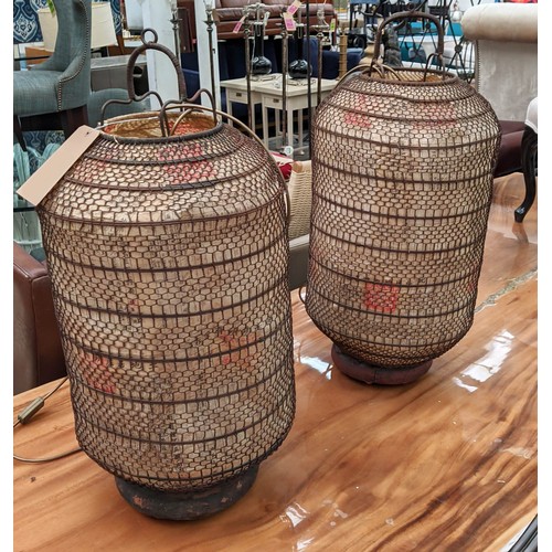 302 - ORIENTAL LANTERNS, a pair, with internal lights, metal and paper wood bases, 77cm H each. (2)