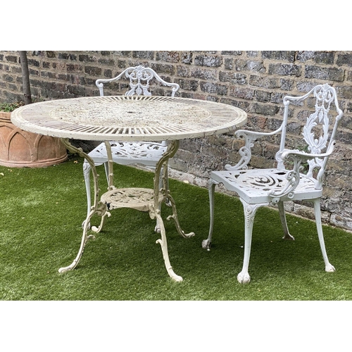 106 - GARDEN TABLE AND CHAIRS, weathered painted cast aluminium circular pierced with two matching chairs,... 