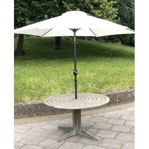 115 - CIRCULAR GARDEN TABLE, weathered teak with circular concentric slatted top and centre column support... 