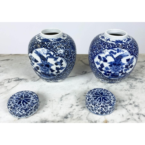 10 - CHINESE LIDDED GINGER JARS, a pair, late 19th century/early 20th blue and white with Phoenix amongst... 