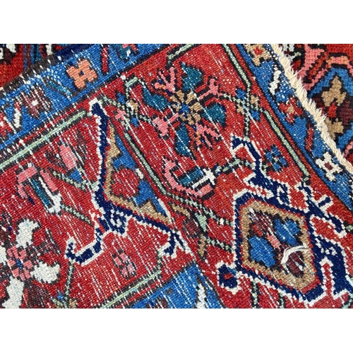 129 - ANTIQUE PERSIAN HERIZ RUG, 207cm x 140cm