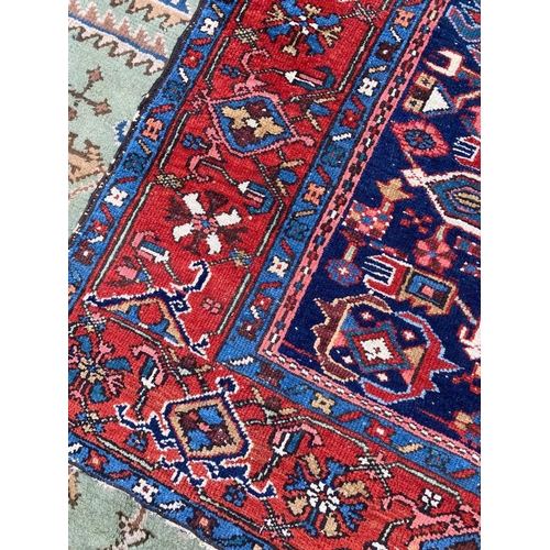 129 - ANTIQUE PERSIAN HERIZ RUG, 207cm x 140cm