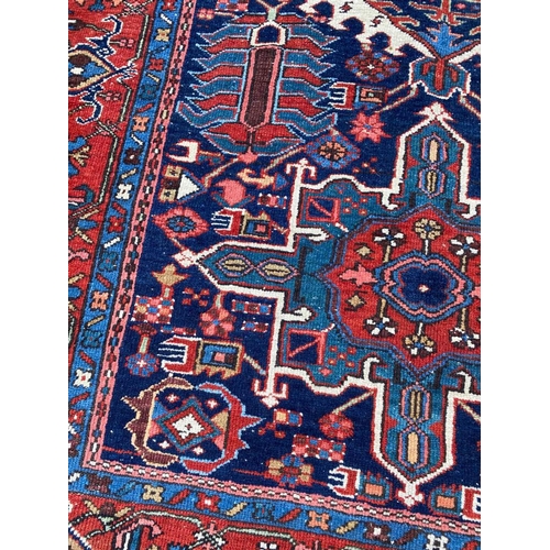 129 - ANTIQUE PERSIAN HERIZ RUG, 207cm x 140cm