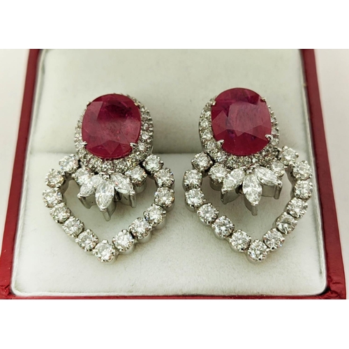 13 - A PAIR OF 18CT WHITE GOLD RUBY AND DIAMOND EARRINGS, each set with a single natural oval mixed cut r... 