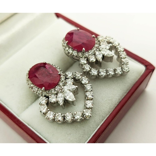 13 - A PAIR OF 18CT WHITE GOLD RUBY AND DIAMOND EARRINGS, each set with a single natural oval mixed cut r... 