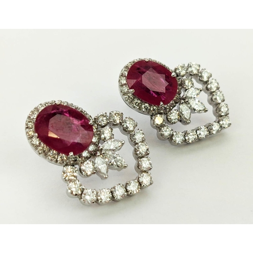 13 - A PAIR OF 18CT WHITE GOLD RUBY AND DIAMOND EARRINGS, each set with a single natural oval mixed cut r... 