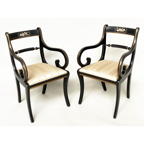 195 - ARMCHAIRS, a pair, Regency style lacquered and gilt lined with music trophy centre and scroll suppor... 