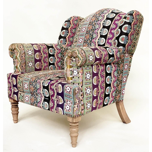 202 - WING ARMCHAIR, 19th century with Indian embroidered upholstery arched backed, scroll arms and turned... 