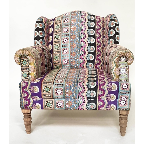 202 - WING ARMCHAIR, 19th century with Indian embroidered upholstery arched backed, scroll arms and turned... 