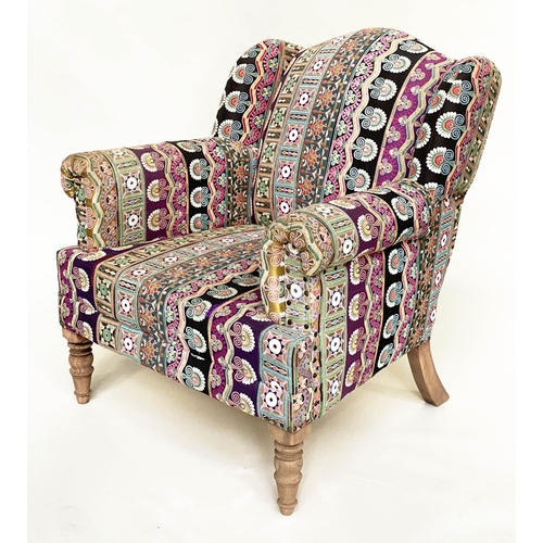 202 - WING ARMCHAIR, 19th century with Indian embroidered upholstery arched backed, scroll arms and turned... 