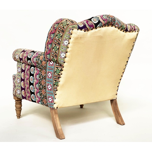 202 - WING ARMCHAIR, 19th century with Indian embroidered upholstery arched backed, scroll arms and turned... 