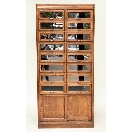 214 - HABERDASHERY CABINET, early/mid 20th century oak by Dudley & Co Ltd, with sixteen glazed drawers abo... 