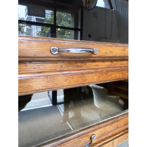 214 - HABERDASHERY CABINET, early/mid 20th century oak by Dudley & Co Ltd, with sixteen glazed drawers abo... 