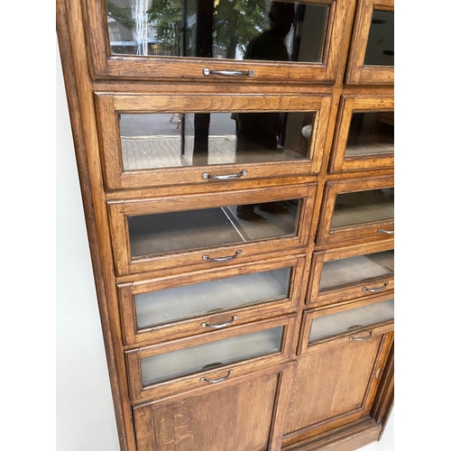 214 - HABERDASHERY CABINET, early/mid 20th century oak by Dudley & Co Ltd, with sixteen glazed drawers abo... 