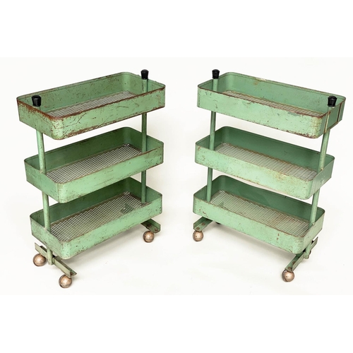 219 - WORKSHOP TROLLEYS, a pair, mid 20th century original green painted metal each with three tiers (on c... 