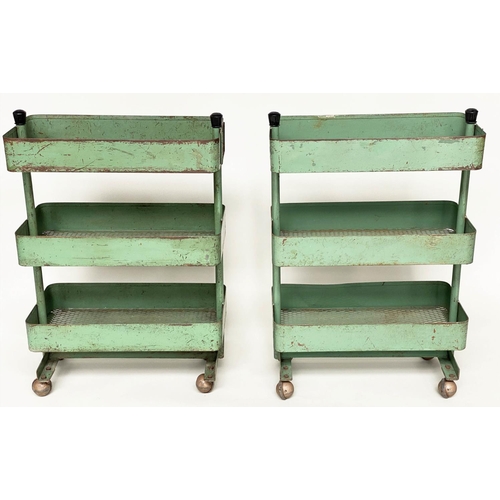 219 - WORKSHOP TROLLEYS, a pair, mid 20th century original green painted metal each with three tiers (on c... 