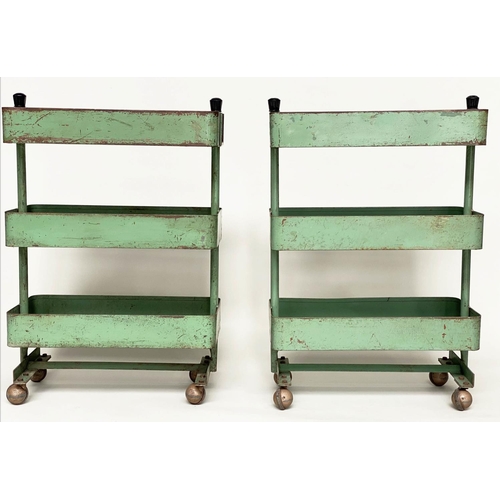 219 - WORKSHOP TROLLEYS, a pair, mid 20th century original green painted metal each with three tiers (on c... 